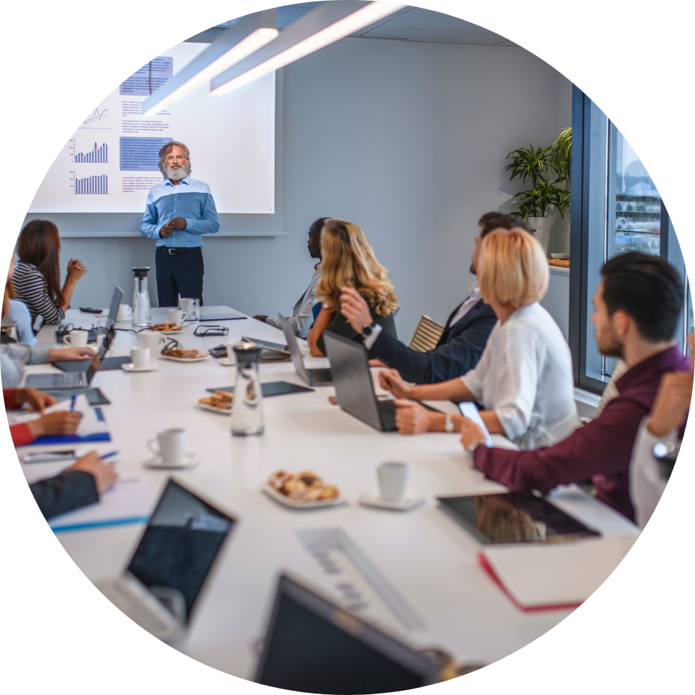 Business presentation in conference room with data charts.